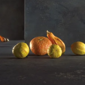 Caesarstone Metallio Black worktop with decorative gourds in a kitchen setting.