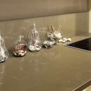 Kitchen counter featuring Unistone Empire Brown Quartz with decor items.