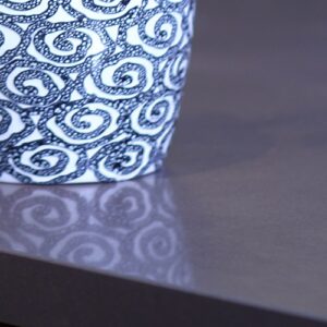 Unistone Cemento Quartz worktop with a decorative cup, highlighting its sleek finish.