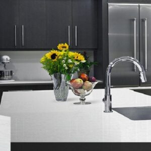 Stylish kitchen featuring Unistone Eramosa White Quartz worktop with sink and appliances