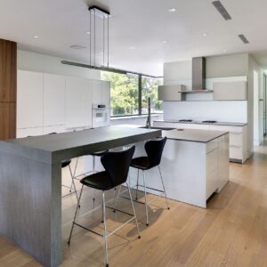 Spacious kitchen with Neolith Cement island in London home