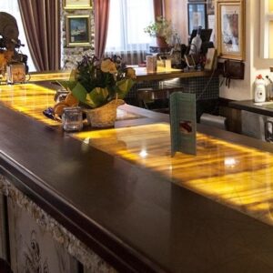 Illuminated Honey Onyx bar counter in a stylish setting