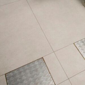 Neolith Pietra Di Osso flooring detail with metal inlays