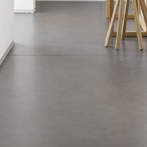 Neolith Pietra Di Piombo flooring in a modern hallway setting.