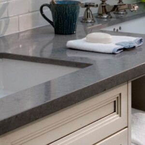 Caesarstone Pebble Quartz countertop in a modern kitchen setting with dual sinks