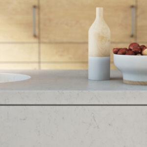 Caesarstone Frosty Carrina worktop in a modern kitchen setting with wooden cabinets.