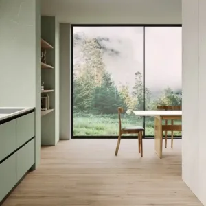 Modern kitchen featuring Ecotone Atlantis Quartz worktop with large windows overlooking a lush landscape.