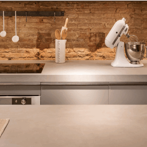 Modern kitchen featuring Neolith Barro worktop, blending with brick and neutral tones.