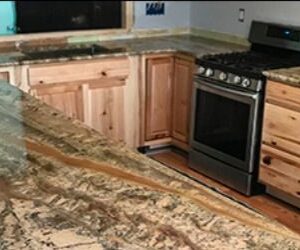 Kitchen featuring Nettuno Bordeaux Granite worktops and wooden cabinets