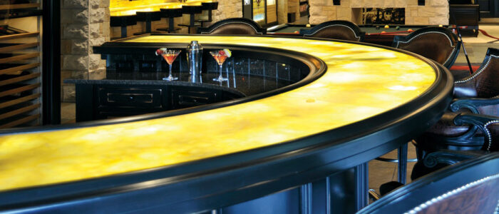 Tiles & Walls Elegant bar counter with Golden Onyx Granite surface in a sophisticated interior