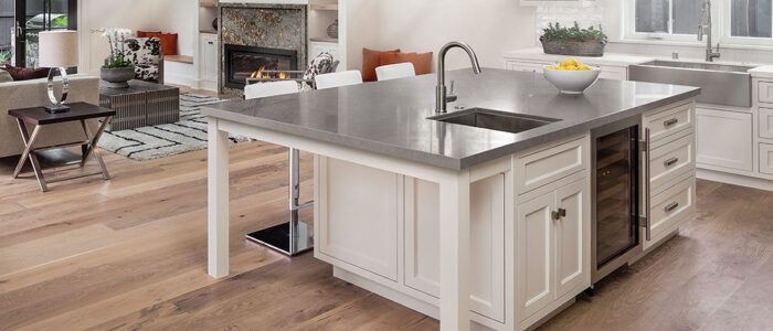 Tiles & Walls Cambria Carrick Quartz kitchen island with sink in a stylish UK home.