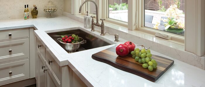 Flooring Cambria Torquay Quartz worktop in a bright kitchen with a sink and fruit