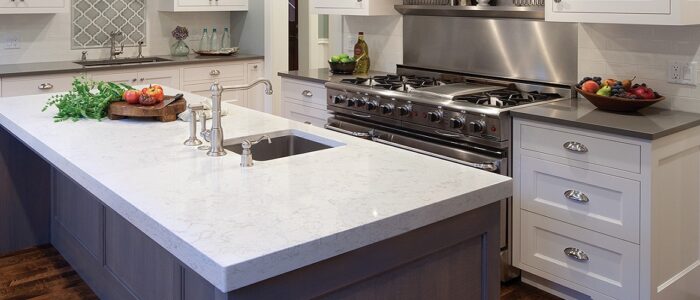 Tiles & Walls Modern kitchen island with Cambria Torquay Quartz worktop and stainless steel appliances