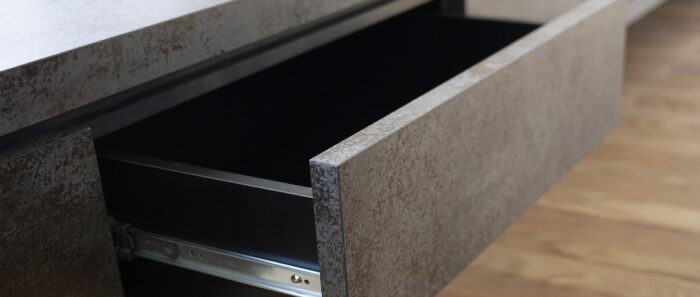 Flooring Laminam Ossido Bruno used in a modern kitchen drawer design
