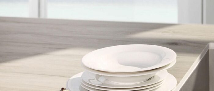 Flooring Laminam Legno Venezia Corda ceramic slab used as a stylish worktop with plates.