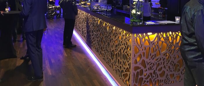 Tiles & Walls Elegant bar area featuring Magna Glaskeramik Champagne Brown surface with ambient lighting, London United Kingdom