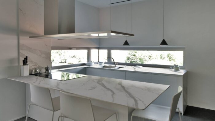 Tiles & Walls Contemporary kitchen in Surrey with Laminam Calacatta Oro Venato countertops