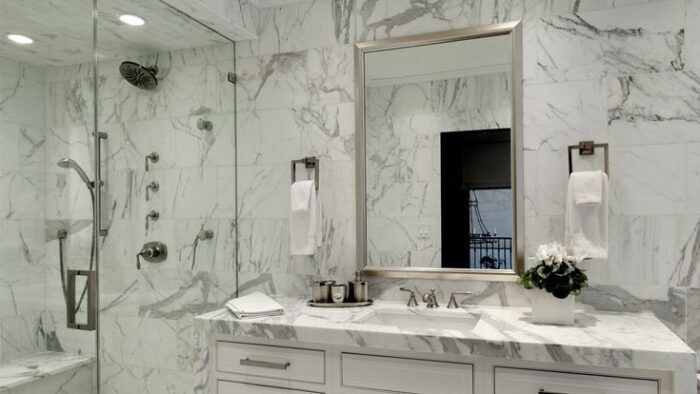 Flooring Luxurious bathroom featuring Bianco Carrara Marble walls, a popular choice in London, United Kingdom.