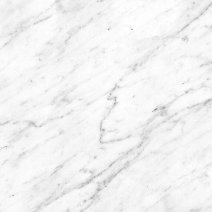 Bianco Carrara Marble - Worktops Close-up of Bianco Carrara Marble texture, showcasing its elegant veining, popular in UK homes.