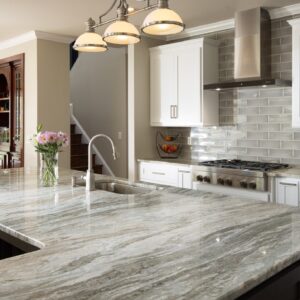 Elegant kitchen featuring Fantasy Brown Marble worktop with white cabinetry.