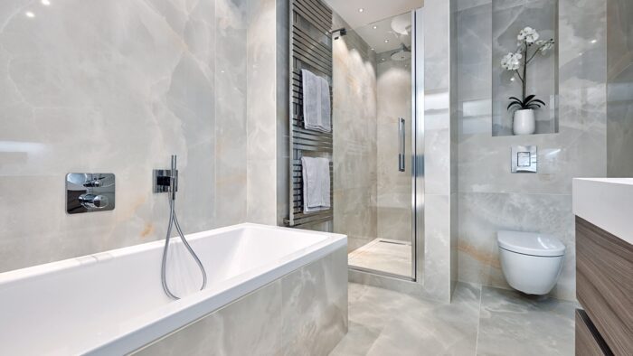Tiles & Walls Luxurious bathroom featuring Grigio Perla Onyx surfaces in a London home