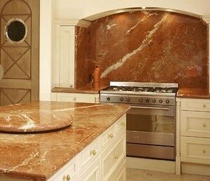 Kitchen featuring Rojo Alicante marble countertops and backsplash in a classic design.