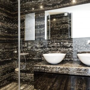 Luxurious bathroom with Portoro Marble walls and countertops in Chelsea