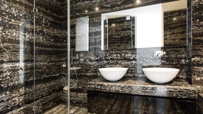 Tiles & Walls Luxurious bathroom with Portoro Marble walls and countertops in Chelsea