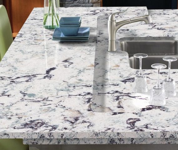 Tiles & Walls Cambria Praa Sands Quartz kitchen island with sink and glasses