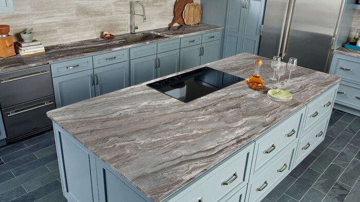 Flooring Fantasy Brown Marble kitchen worktop in a modern setting with blue cabinets.