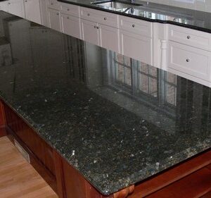 Spacious kitchen island with Peacock Green Granite in Surrey