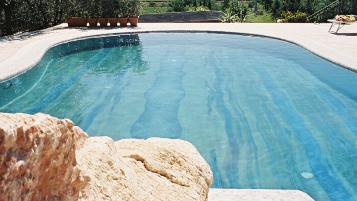 Flooring Swimming pool with Azul Imperial quartzite tiles in a sunny garden