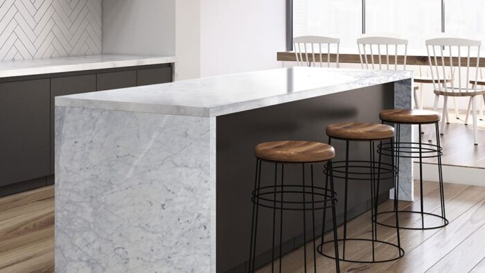Flooring Modern kitchen island featuring Bianco Carrara Extra Marble in a bright, airy space.