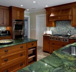 Kitchen featuring Autumn Green Granite countertops and wooden cabinetry in a stylish setting.