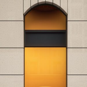 Compac Travertine Composite Stone used in modern architectural design with orange accents.