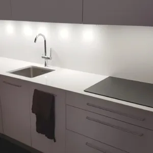 Sleek kitchen setup with Technistone Crystal Diamond Quartz worktop, integrated sink, and induction hob.