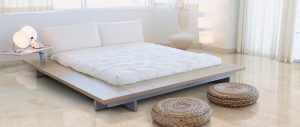 Modern minimalist bedroom with cream stone flooring