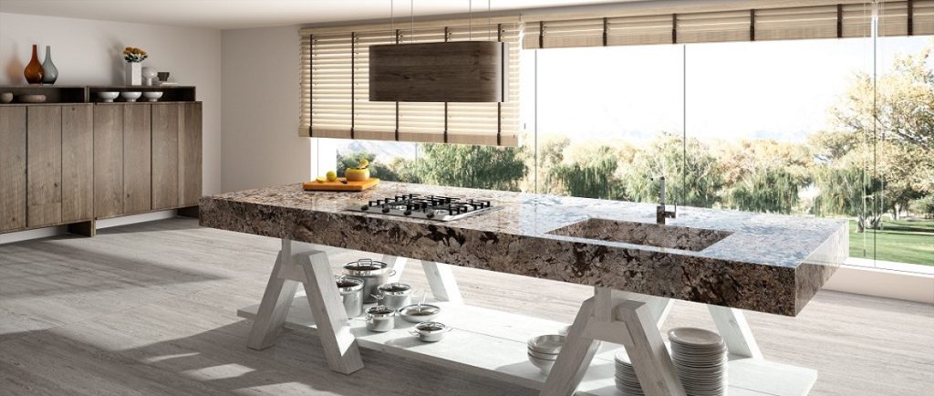 Modern kitchen with a large granite worktop and scenic view
