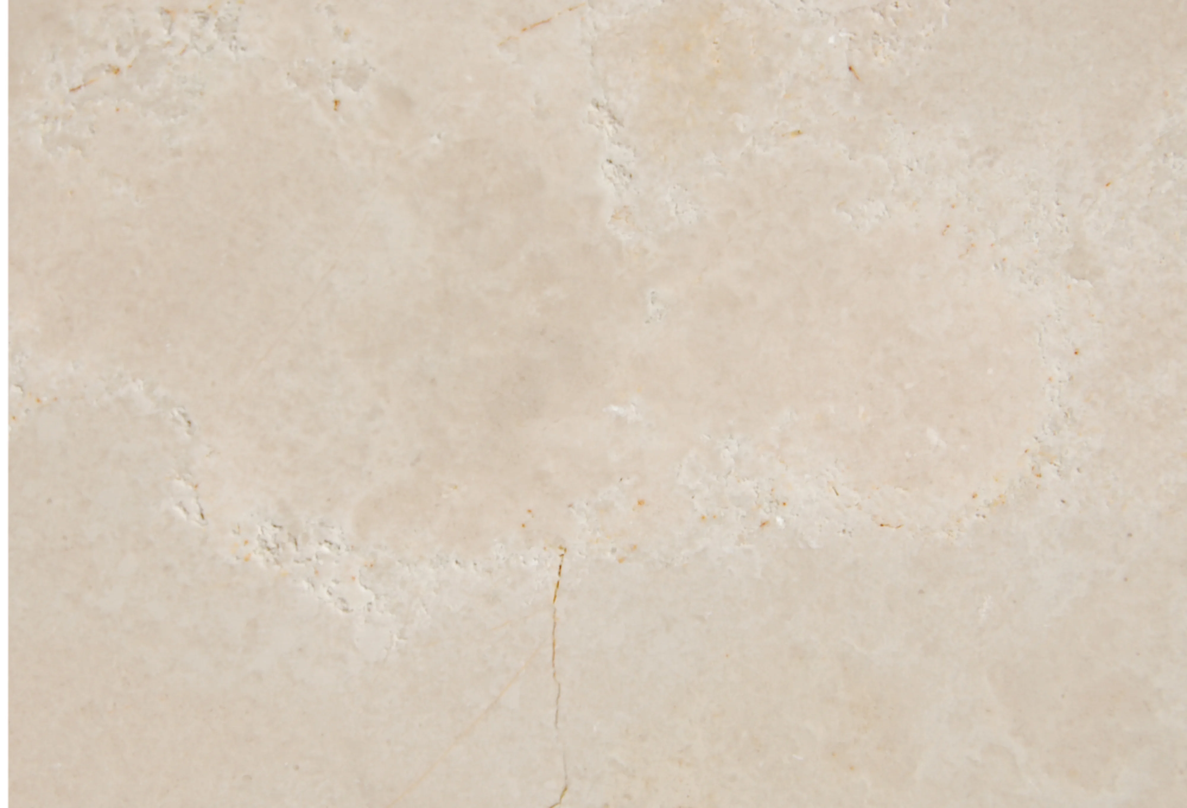 A beige, solid limestone surface.