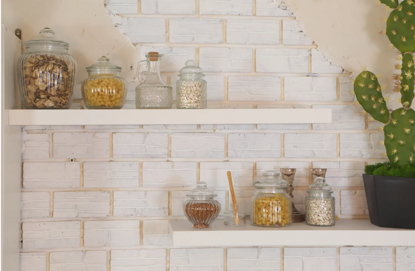 How to add value to your home. A stone wall with two floating shelves and a cactus.