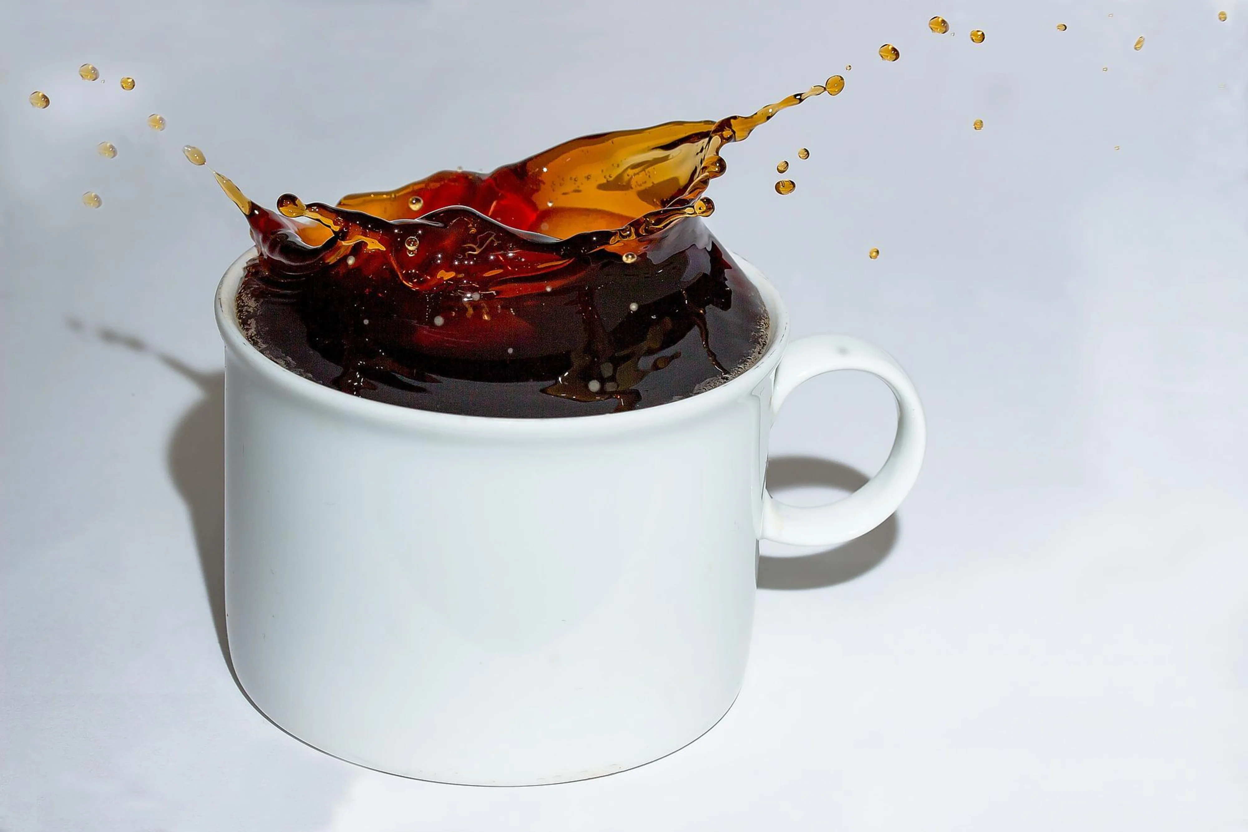 A cup of coffee about to spill.