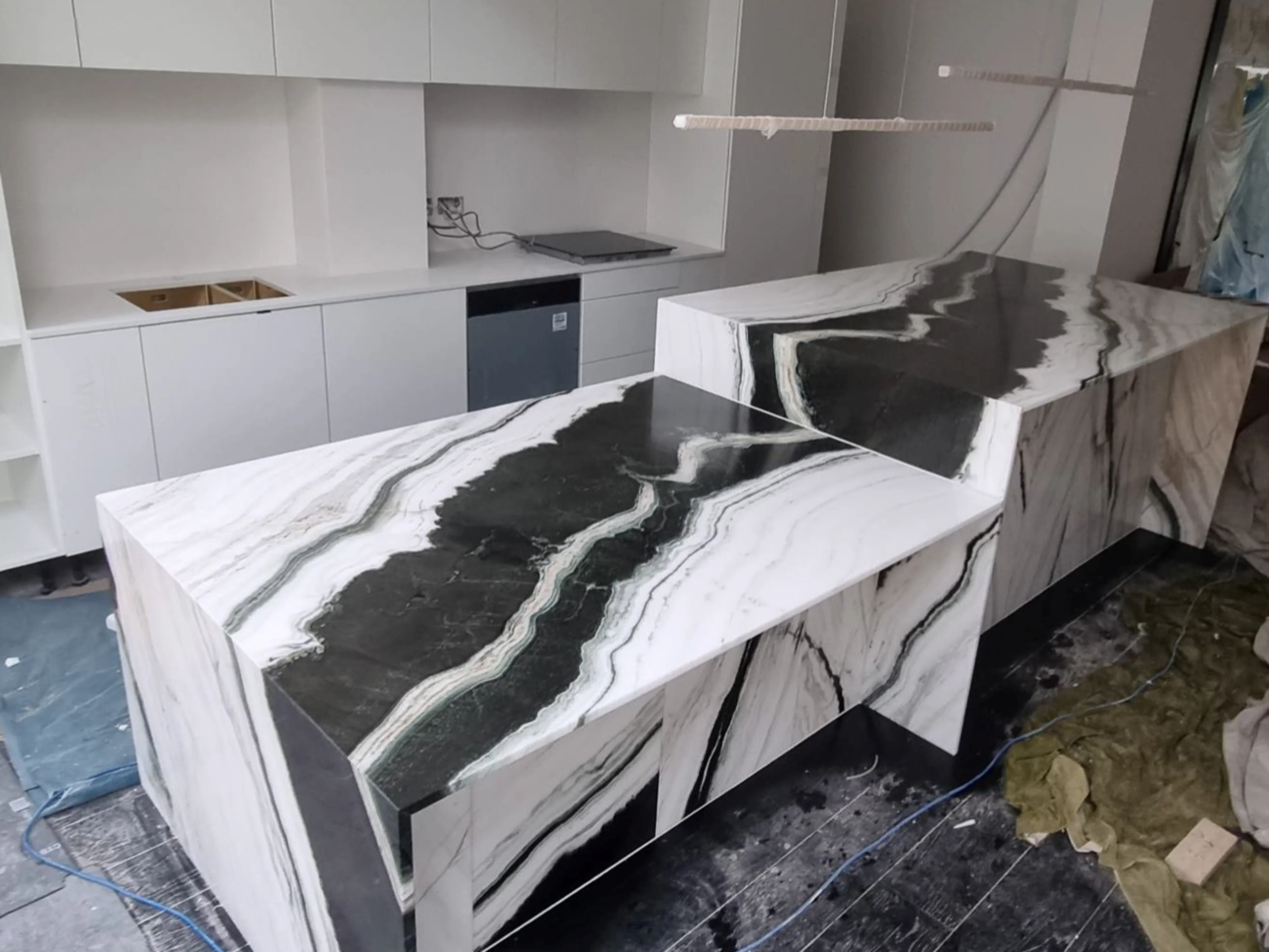 Two panda white marble worktops that have just been installed in a kitchen.